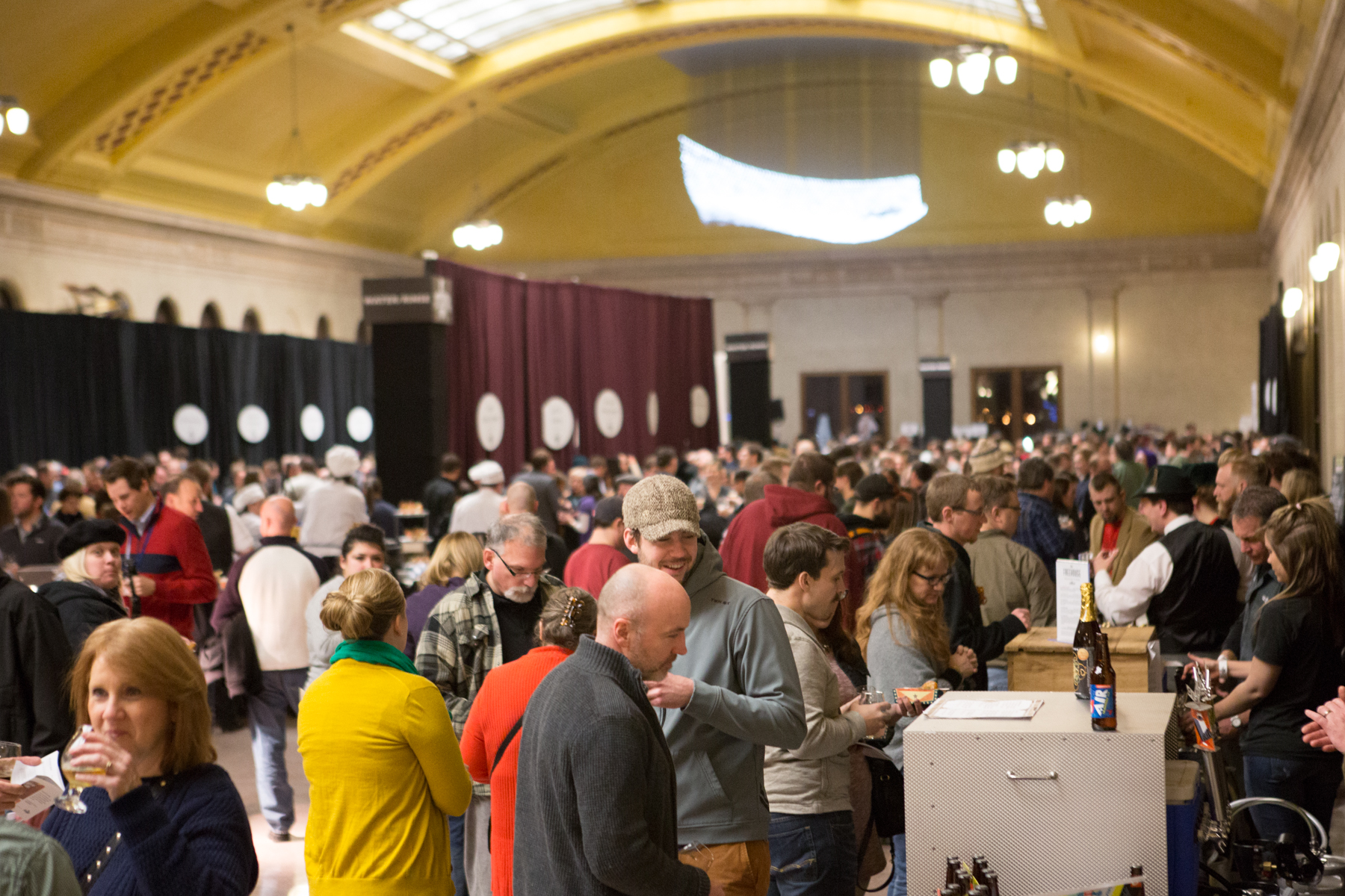 Large event crowd in Waiting Room looking at vendor booths