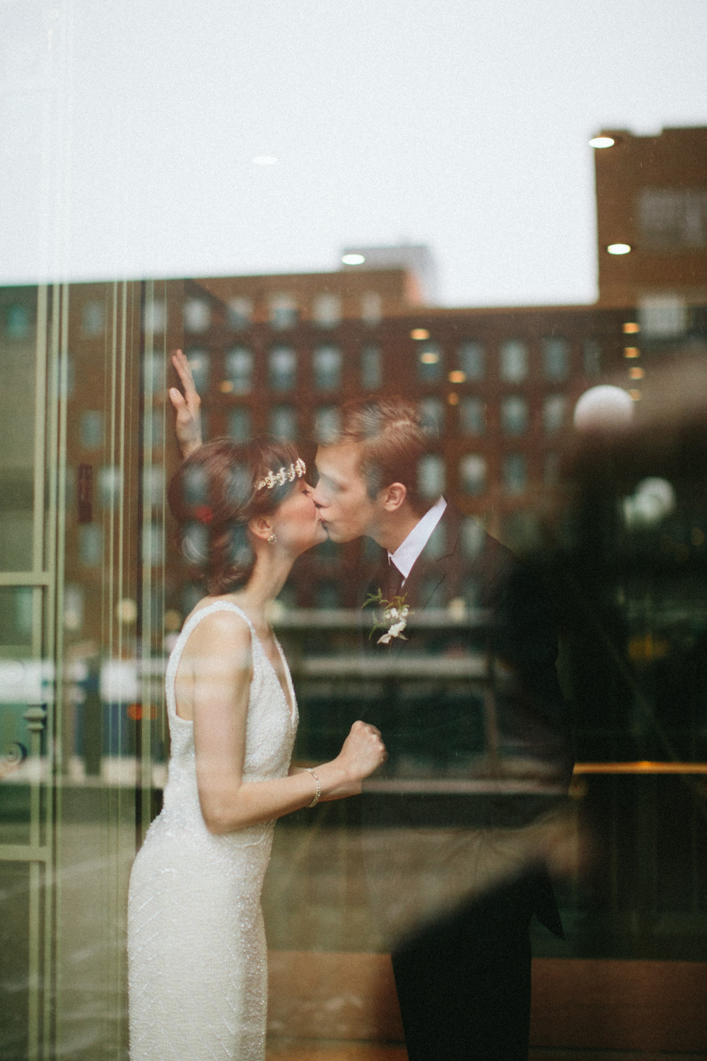 Bride and groom kissing in historic elevator