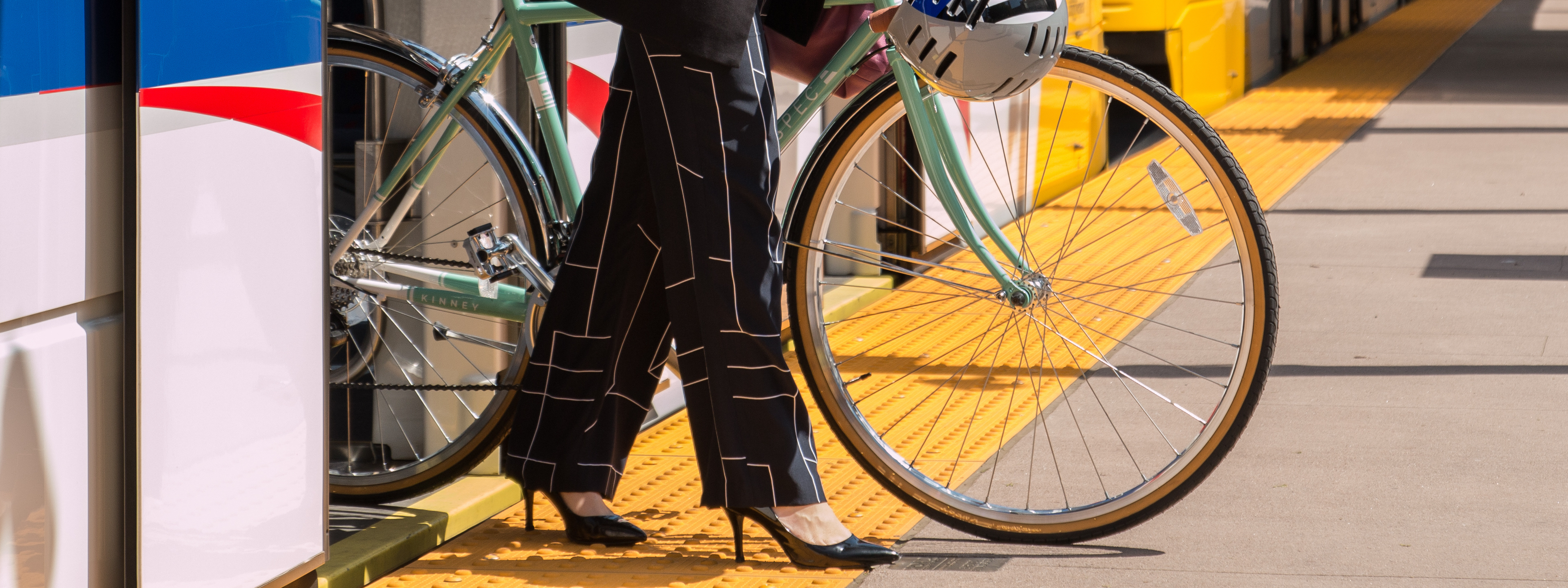 Woman walking out metro with a bike