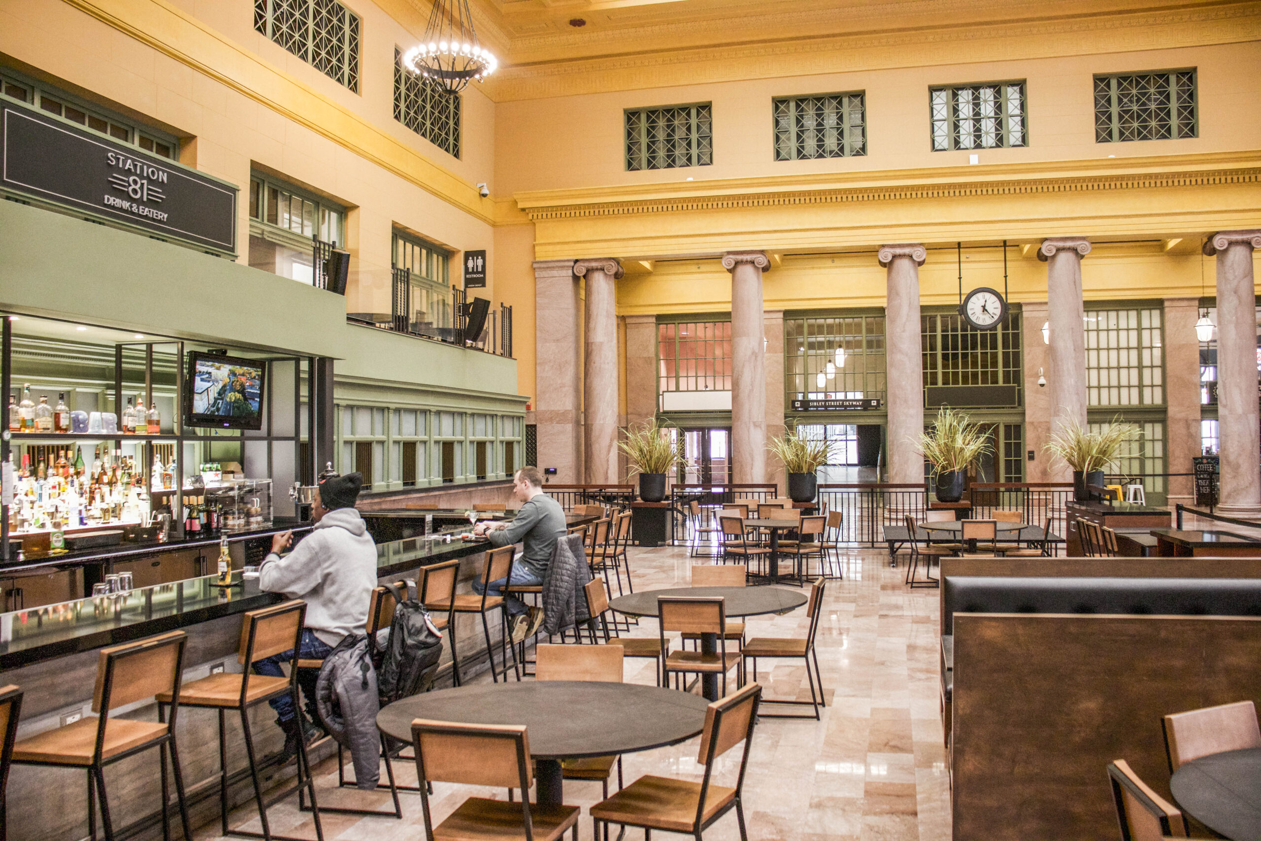 People eating at the Station 81 bar inside Union Depot