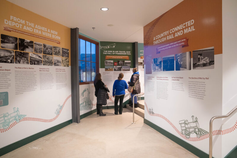 People looking at the walls in the land to legacy museum at Union Depot