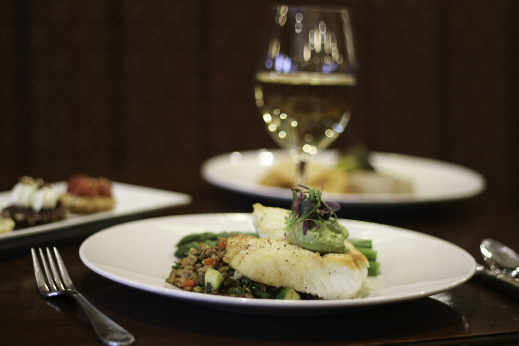 salmon dish and wine glass