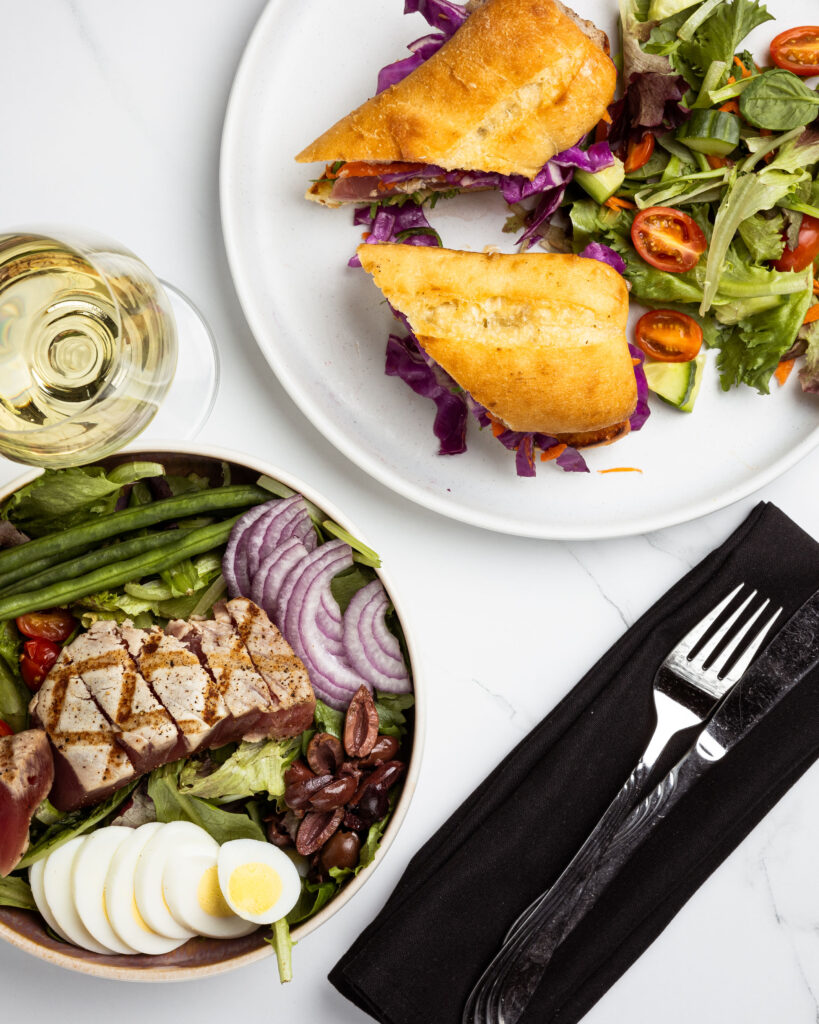 restaurant table setting with salad and sandwich